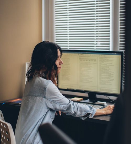 A person working at an office desk looking comfortable and poised.
